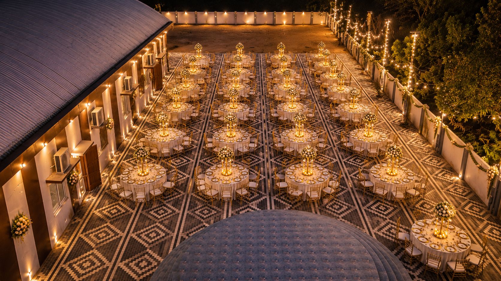 Open-air reception dining setup with warm lights