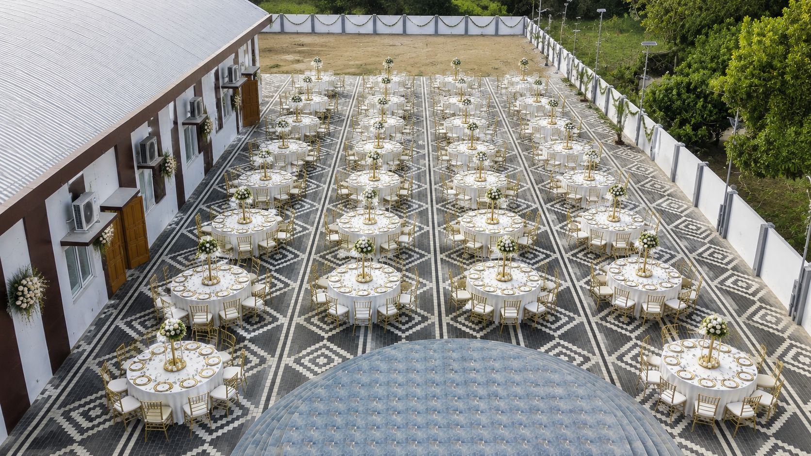 Outdoor celebration area arranged with round dining tables
