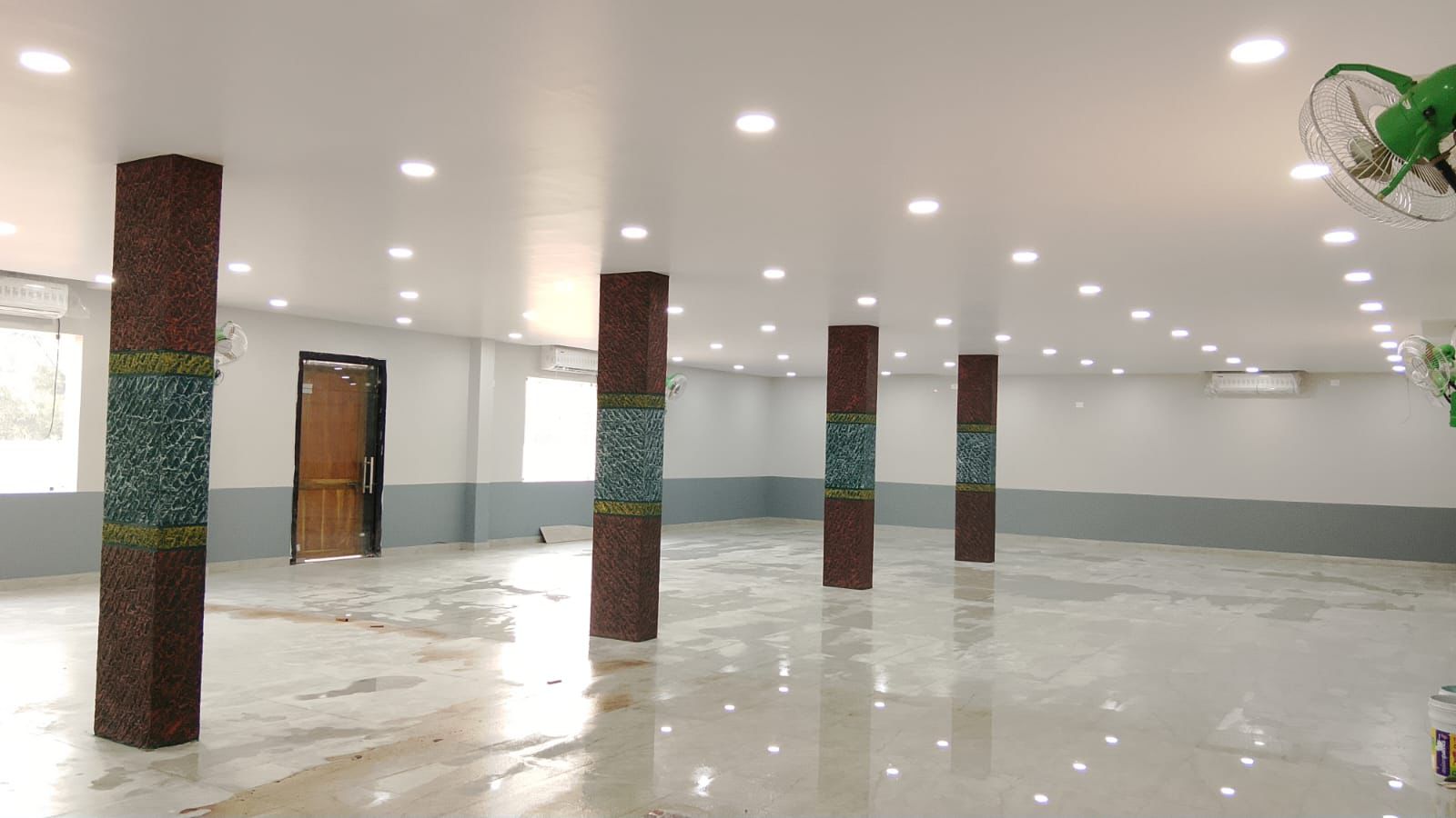 Small function hall interior with polished floor and pillars